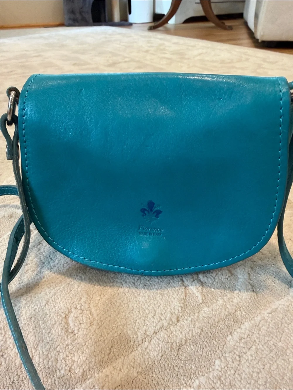 Vintage Florence Made in Italy genuine leather crossbody saddle bag in teal.